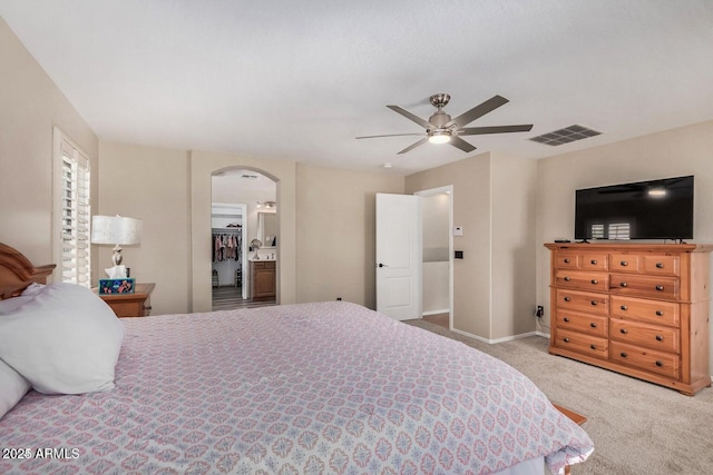 9566 N 83rd Dr, Peoria, AZ 85345 - bedroom with visible vents, baseboards, arched walkways, carpet, and a ceiling fan