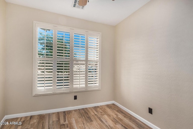 9566 N 83rd Dr, Peoria, AZ 85345 - spare room with wood finished floors, a ceiling fan, visible vents, and baseboards