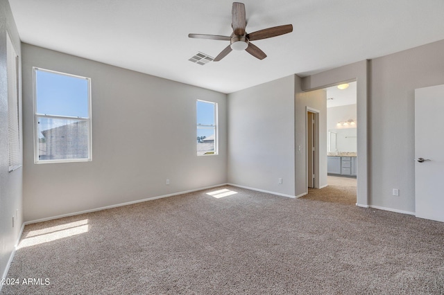 carpeted empty room featuring ceiling fan