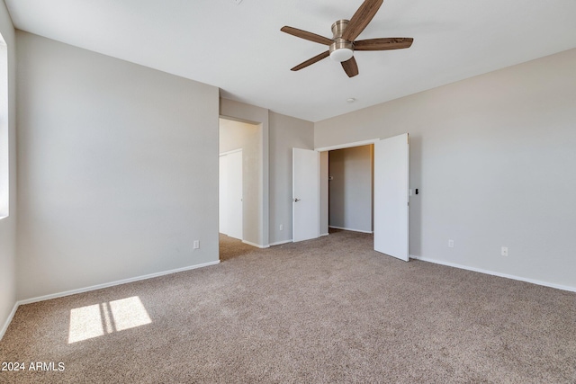 empty room with carpet and ceiling fan