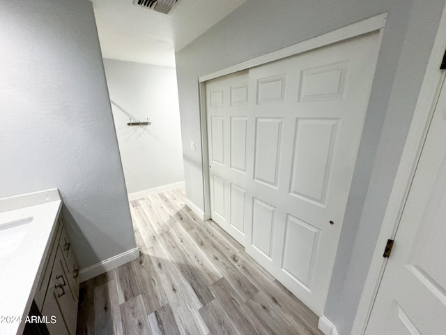 bathroom featuring hardwood / wood-style flooring and vanity