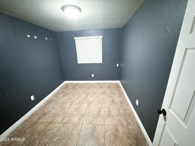 empty room featuring a textured ceiling