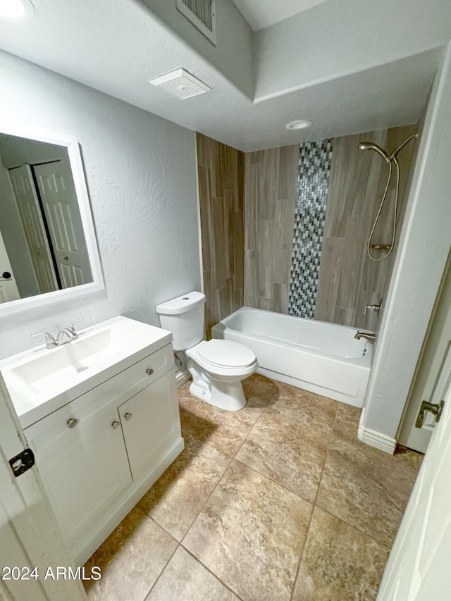 full bathroom featuring tile patterned floors, vanity, toilet, and tiled shower / bath