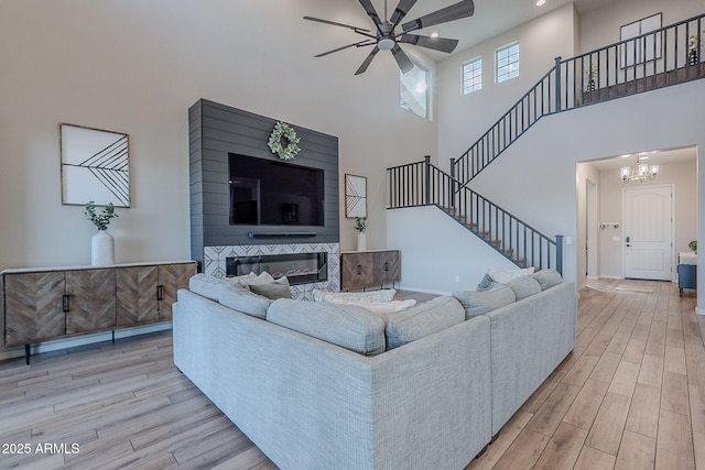 22771 N 98th Dr, Peoria, AZ 85383 - living area with ceiling fan, light wood-style flooring, stairs, recessed lighting, and a towering ceiling