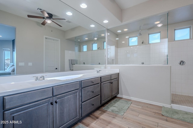 22771 N 98th Dr, Peoria, AZ 85383 - bathroom with double vanity, a walk in shower, wood finished floors, ceiling fan, and ensuite bathroom
