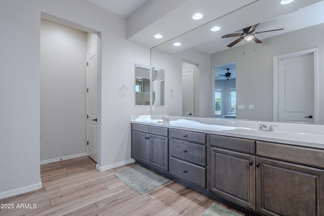 22771 N 98th Dr, Peoria, AZ 85383 - full bath featuring wood finished floors, ceiling fan, baseboards, recessed lighting, and double vanity