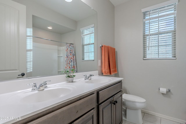 22771 N 98th Dr, Peoria, AZ 85383 - full bath featuring toilet, tile patterned floors, double vanity, baseboards, and a shower with shower curtain