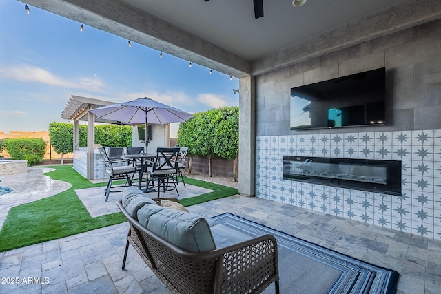 22771 N 98th Dr, Peoria, AZ 85383 - view of patio with a tile fireplace, a fenced backyard, and outdoor dining space