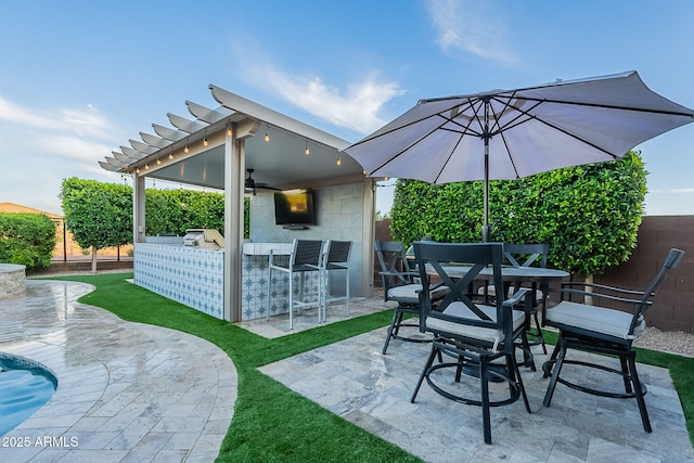 22771 N 98th Dr, Peoria, AZ 85383 - view of patio / terrace with a fenced backyard, exterior bar, ceiling fan, and exterior kitchen