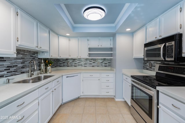 kitchen featuring sink, a raised ceiling, white cabinetry, and stainless steel appliances