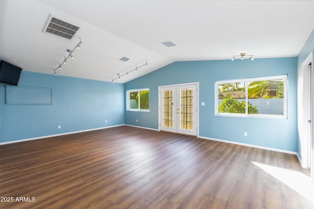 unfurnished room featuring french doors, wood-type flooring, and lofted ceiling