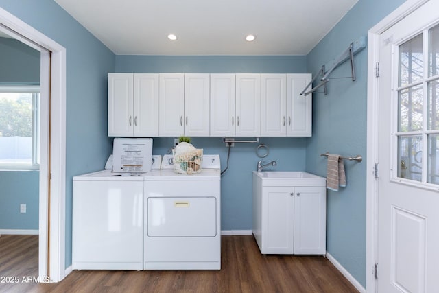 washroom with cabinets, dark wood-type flooring, washer and dryer, and sink