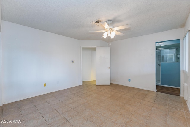 spare room with a textured ceiling and ceiling fan