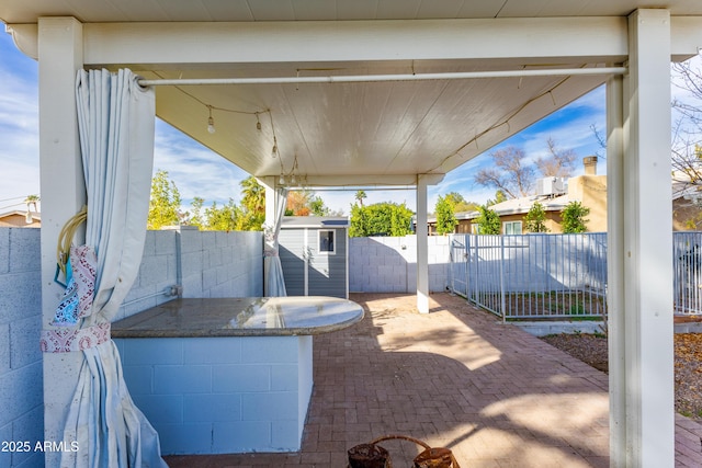 view of patio with a storage shed