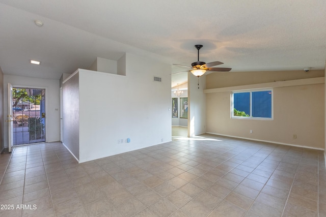 tiled spare room with ceiling fan and lofted ceiling