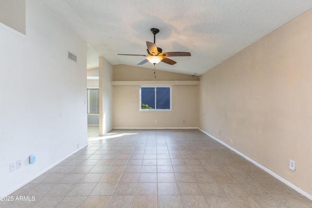 spare room with ceiling fan, light tile patterned flooring, a textured ceiling, and vaulted ceiling