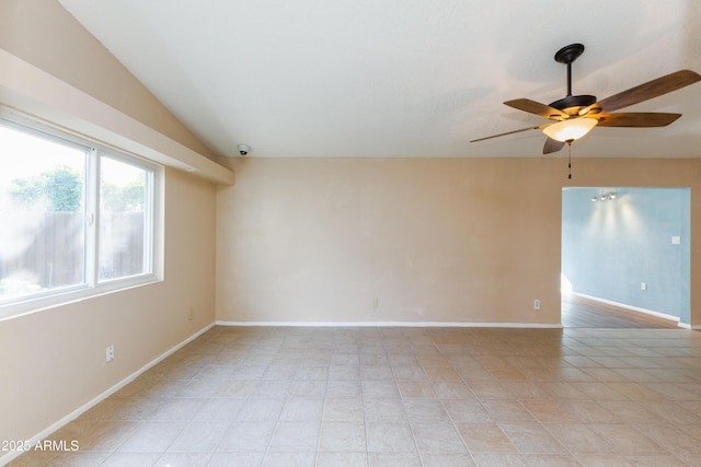 empty room with ceiling fan and lofted ceiling