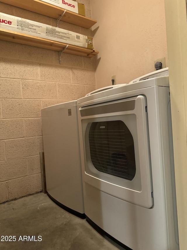 clothes washing area featuring washer and dryer