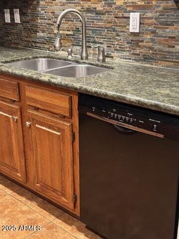 kitchen featuring light tile patterned flooring, sink, light stone counters, dishwasher, and decorative backsplash