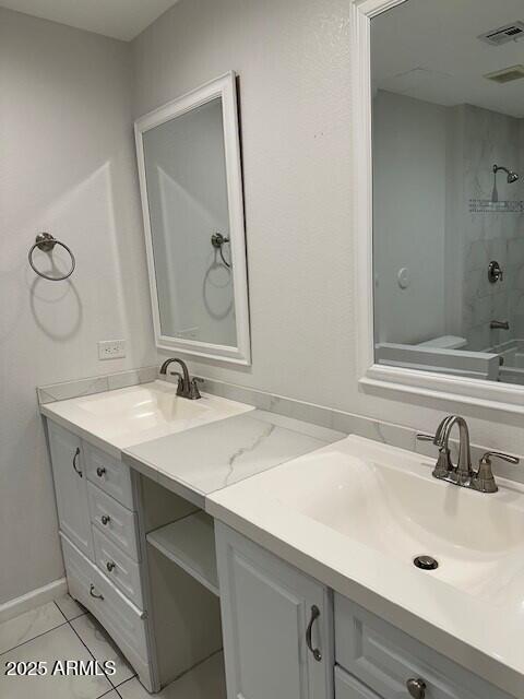 bathroom with tiled shower / bath and vanity