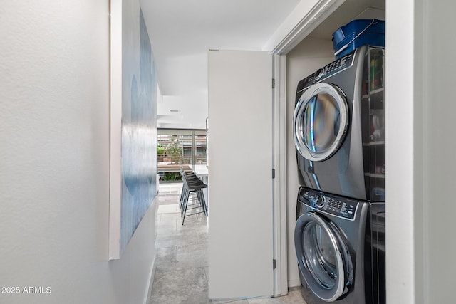 7141 E Rancho Vista Dr Unit 6007, Scottsdale, AZ 85251 - laundry room with stacked washer / dryer and baseboards