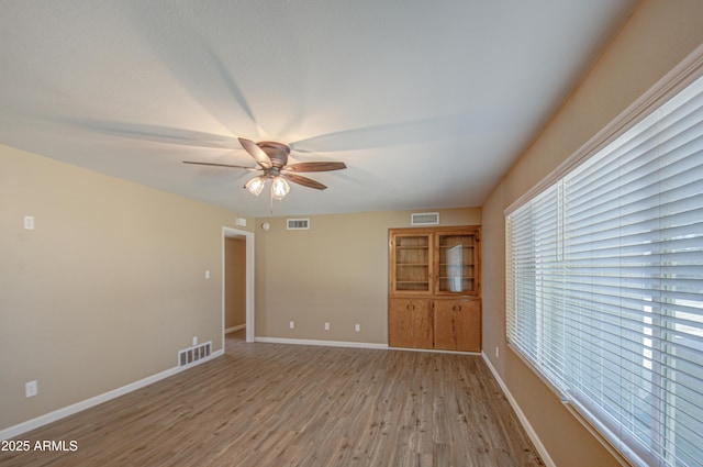 spare room featuring ceiling fan and light wood-type flooring