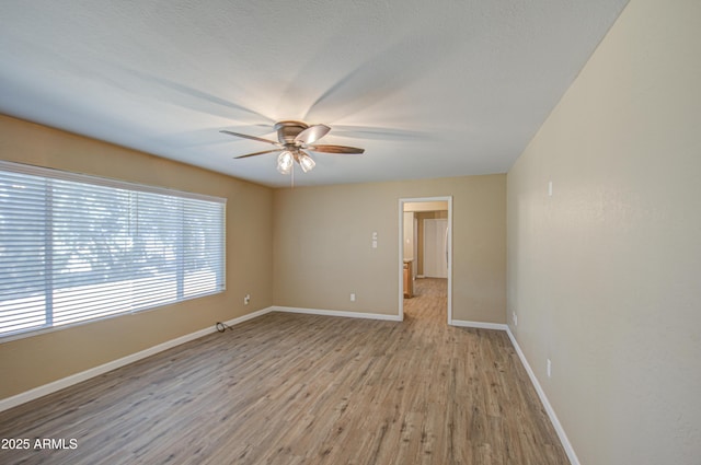 unfurnished room featuring ceiling fan and light hardwood / wood-style flooring