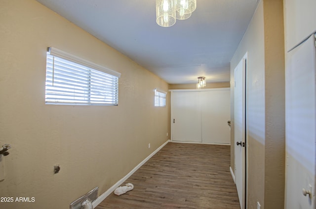 corridor with hardwood / wood-style flooring