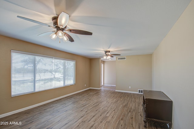 unfurnished room with hardwood / wood-style flooring and ceiling fan