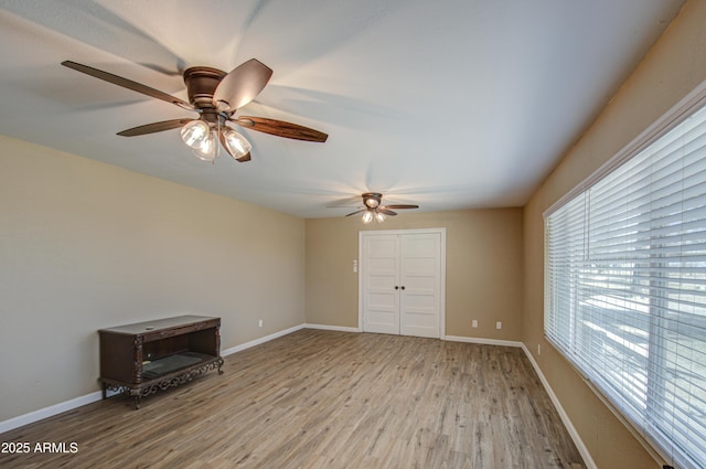 spare room featuring a healthy amount of sunlight and light hardwood / wood-style floors