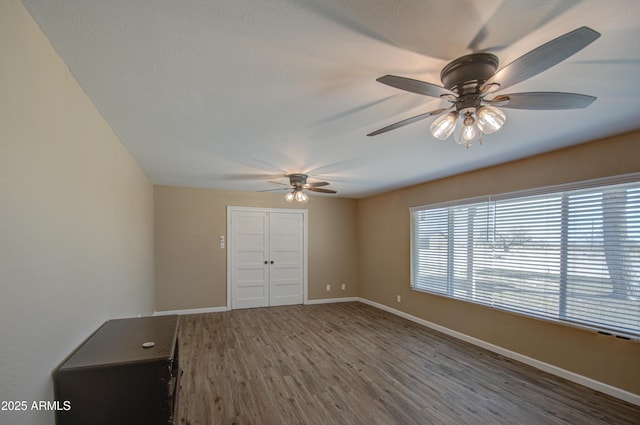 unfurnished bedroom featuring hardwood / wood-style flooring and ceiling fan