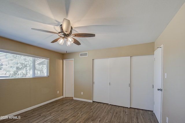 unfurnished bedroom with hardwood / wood-style flooring and ceiling fan