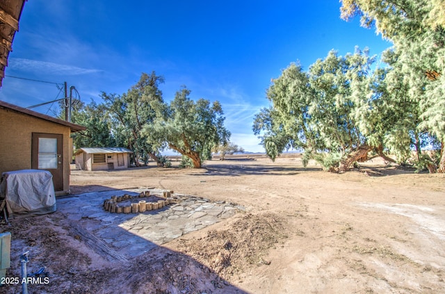 view of yard with an outdoor fire pit