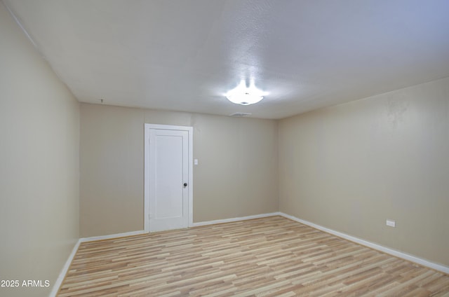 empty room with light hardwood / wood-style flooring