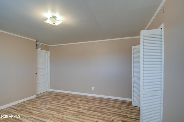 unfurnished bedroom featuring ornamental molding, light hardwood / wood-style floors, and a closet