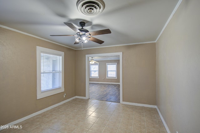 empty room with crown molding, light tile patterned floors, and ceiling fan