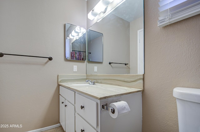 bathroom featuring vanity and toilet