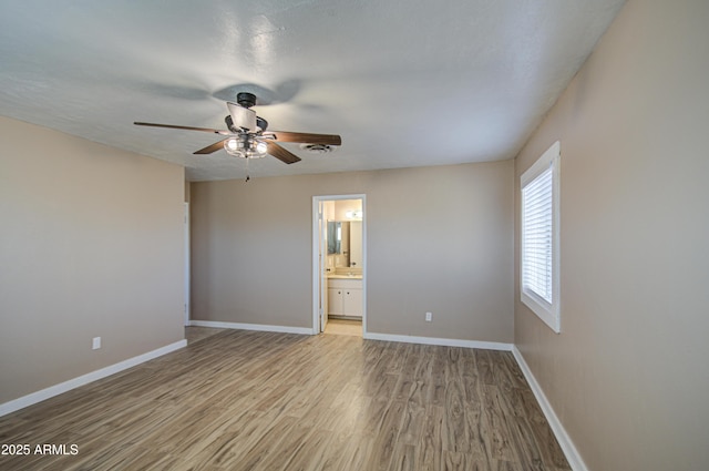 empty room with ceiling fan and light wood-type flooring