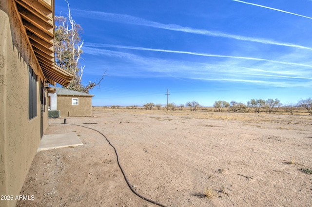 view of yard with a rural view