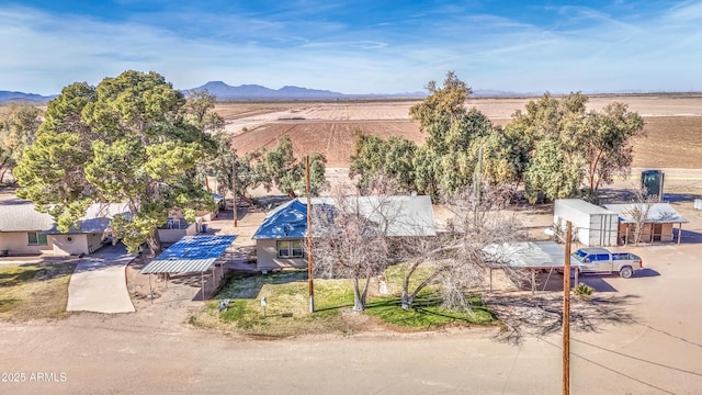 birds eye view of property with a mountain view and a rural view