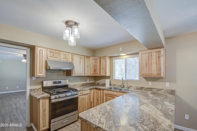 kitchen featuring light wood-type flooring, light brown cabinetry, sink, and stainless steel gas stove