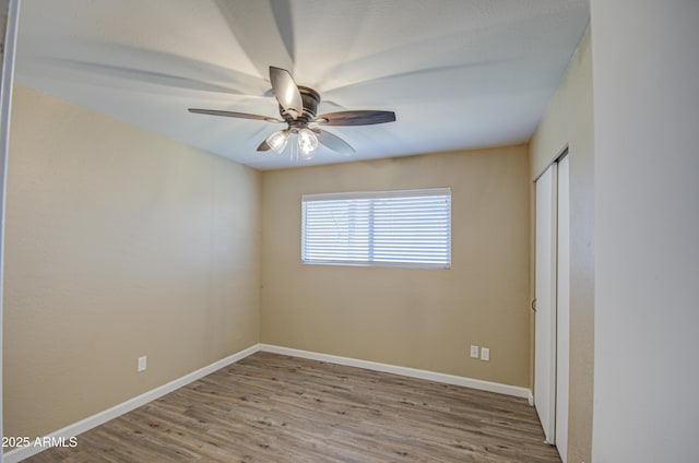 unfurnished room featuring ceiling fan and light wood-type flooring