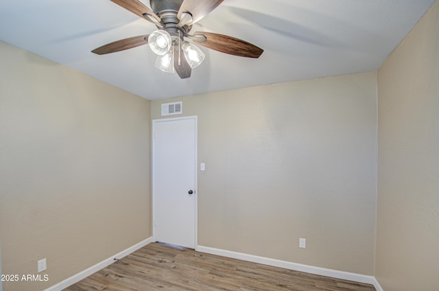 empty room with ceiling fan and light hardwood / wood-style flooring