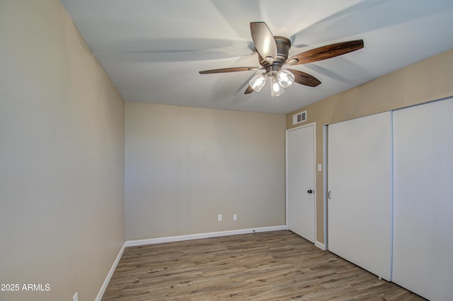 unfurnished bedroom featuring a closet, ceiling fan, and light hardwood / wood-style flooring