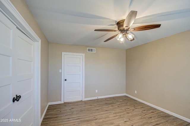 spare room featuring ceiling fan and light wood-type flooring