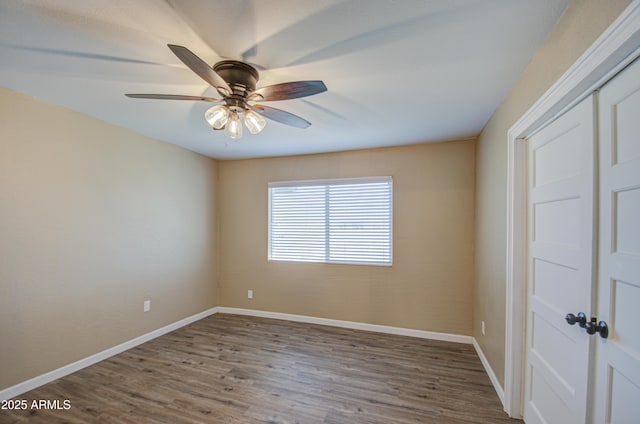 spare room with hardwood / wood-style flooring and ceiling fan