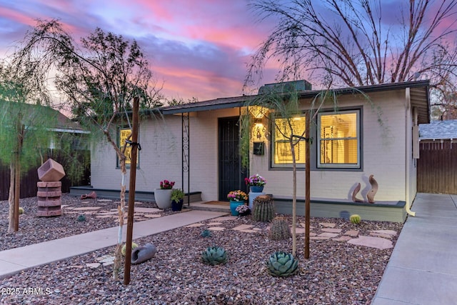 ranch-style home featuring brick siding