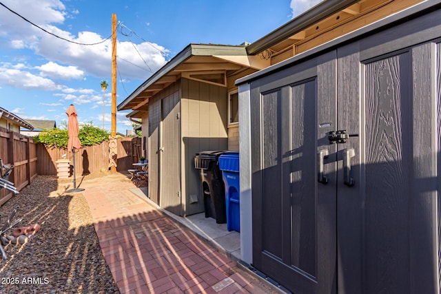 entrance to property with a patio area and fence
