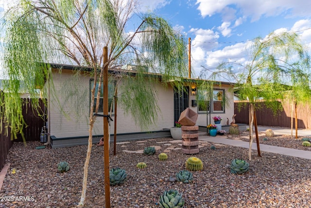 view of front facade with fence and a patio area