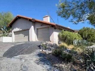 view of home's exterior with driveway and an attached garage